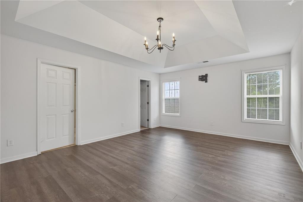 1644 Sandy Beach Point Lawrenceville, GA 30043 - Photo 42 of 60 a view of an empty room with wooden floor and a window
