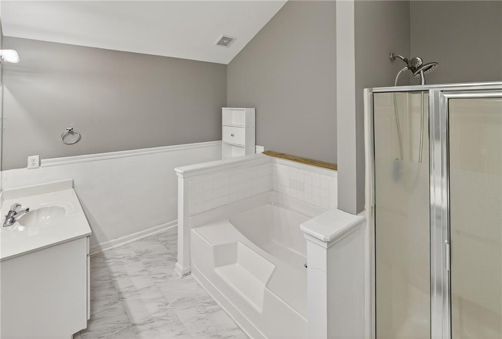 1644 Sandy Beach Point Lawrenceville, GA 30043 - Photo 43 of 60 a bathroom with a bathtub