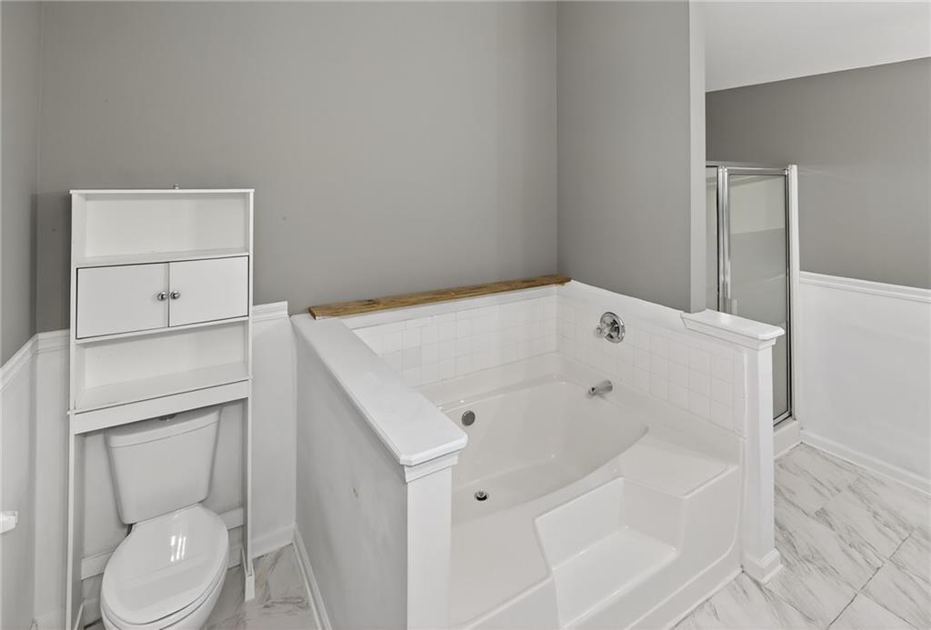 1644 Sandy Beach Point Lawrenceville, GA 30043 - Photo 45 of 60 a bathroom with a sink a toilet and vanity
