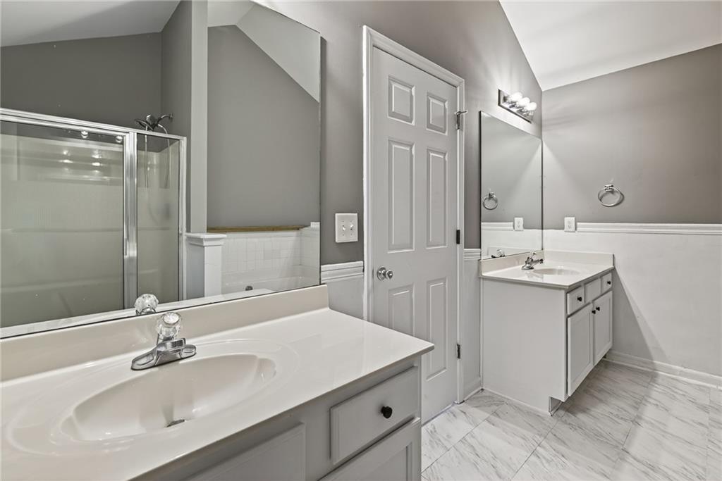 1644 Sandy Beach Point Lawrenceville, GA 30043 - Photo 46 of 60 a bathroom with a sink double vanity and a mirror