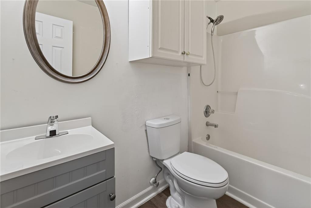 1644 Sandy Beach Point Lawrenceville, GA 30043 - Photo 50 of 60 a bathroom with a sink a toilet and a mirror