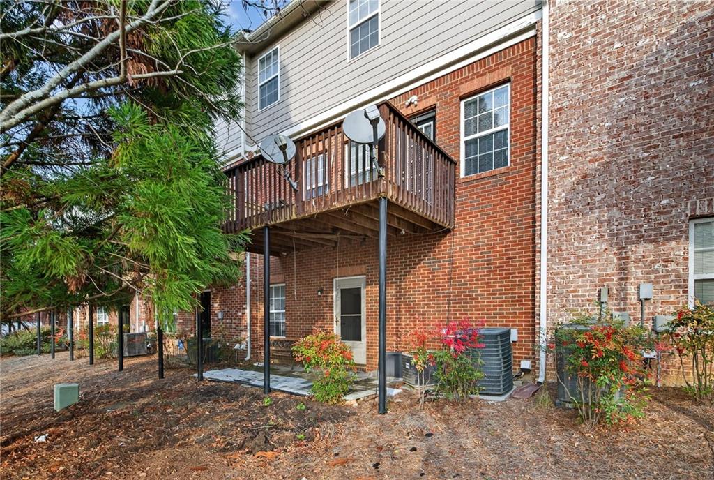 1644 Sandy Beach Point Lawrenceville, GA 30043 - Photo 60 of 60 a view of a house with a yard and table and chairs under an umbrella