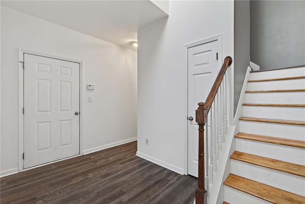 1644 Sandy Beach Point Lawrenceville, GA 30043 - Photo 7 of 60 a view of a hallway with wooden floor and entryway