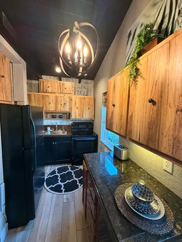 a kitchen with granite countertop a table and chairs