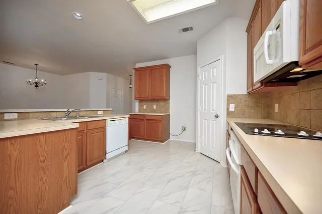 a kitchen with a stove a sink and a refrigerator