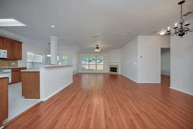 a view of a kitchen with wooden floor and a kitchen