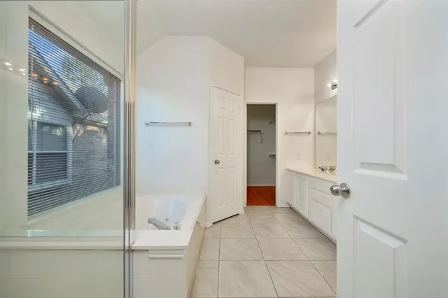 a bathroom with a tub and shower