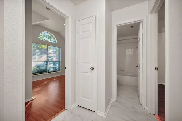 a view of an entryway with wooden floor