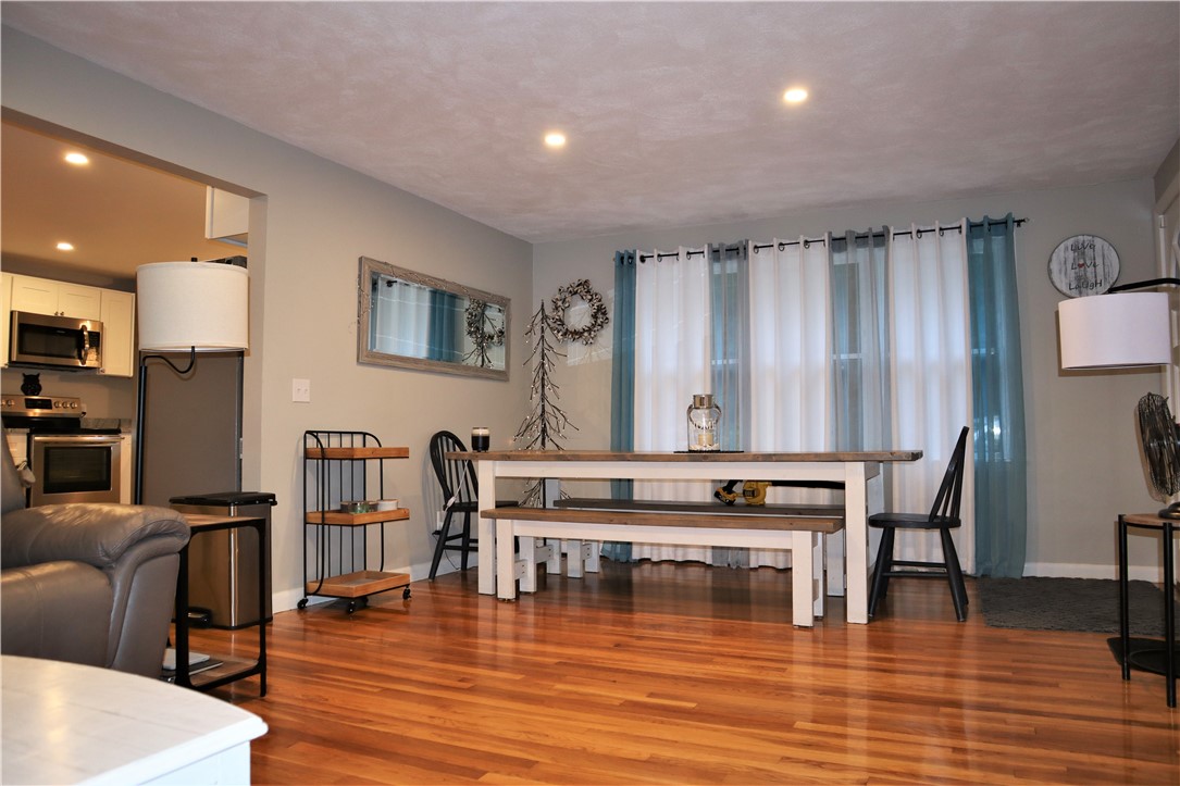 50 Colvintown Road Coventry, RI 02816 - Photo 15 of 29 Nice Spacious Dining Area open to Living room Room Featuring a Wood-Burning Fireplace & Gleaming Hardwood Floors!