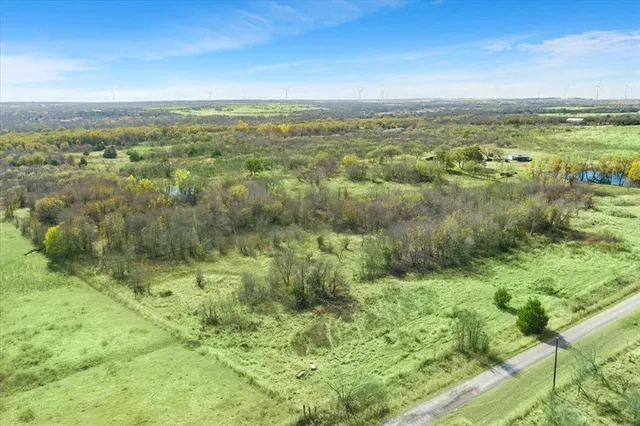 a view of a green field with an ocean view