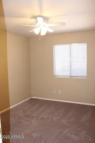 a bathroom with a granite countertop toilet sink and mirror