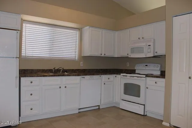 a kitchen with stainless steel appliances a stove a microwave and a refrigerator