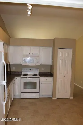 a kitchen with refrigerator and window