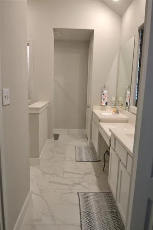 a bathroom with a sink a toilet and mirror