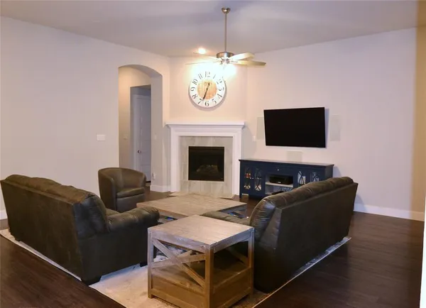 a living room with furniture a fireplace and a flat screen tv