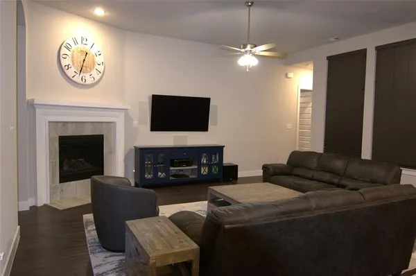 a living room with furniture a fireplace and a flat screen tv