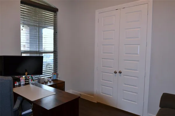 a view of a workspace with furniture and a window