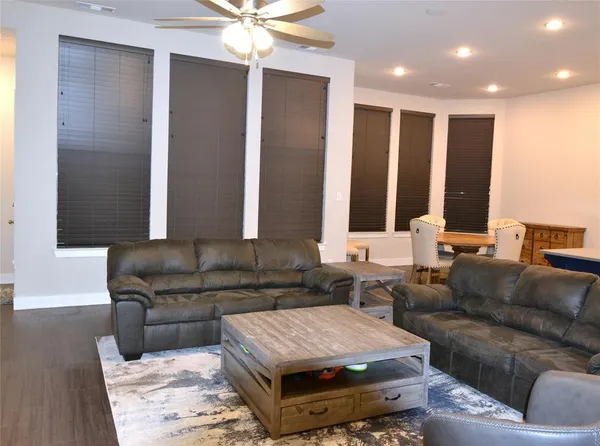 a living room with furniture and a mirror