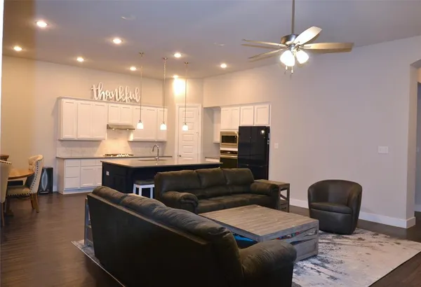 a living room with furniture and a chandelier