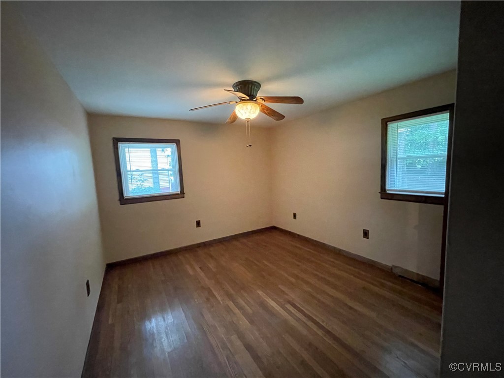 2806 Trarich Road Petersburg, VA 23805 - Photo 7 of 14 Unfurnished room with ceiling fan and dark wood-ty