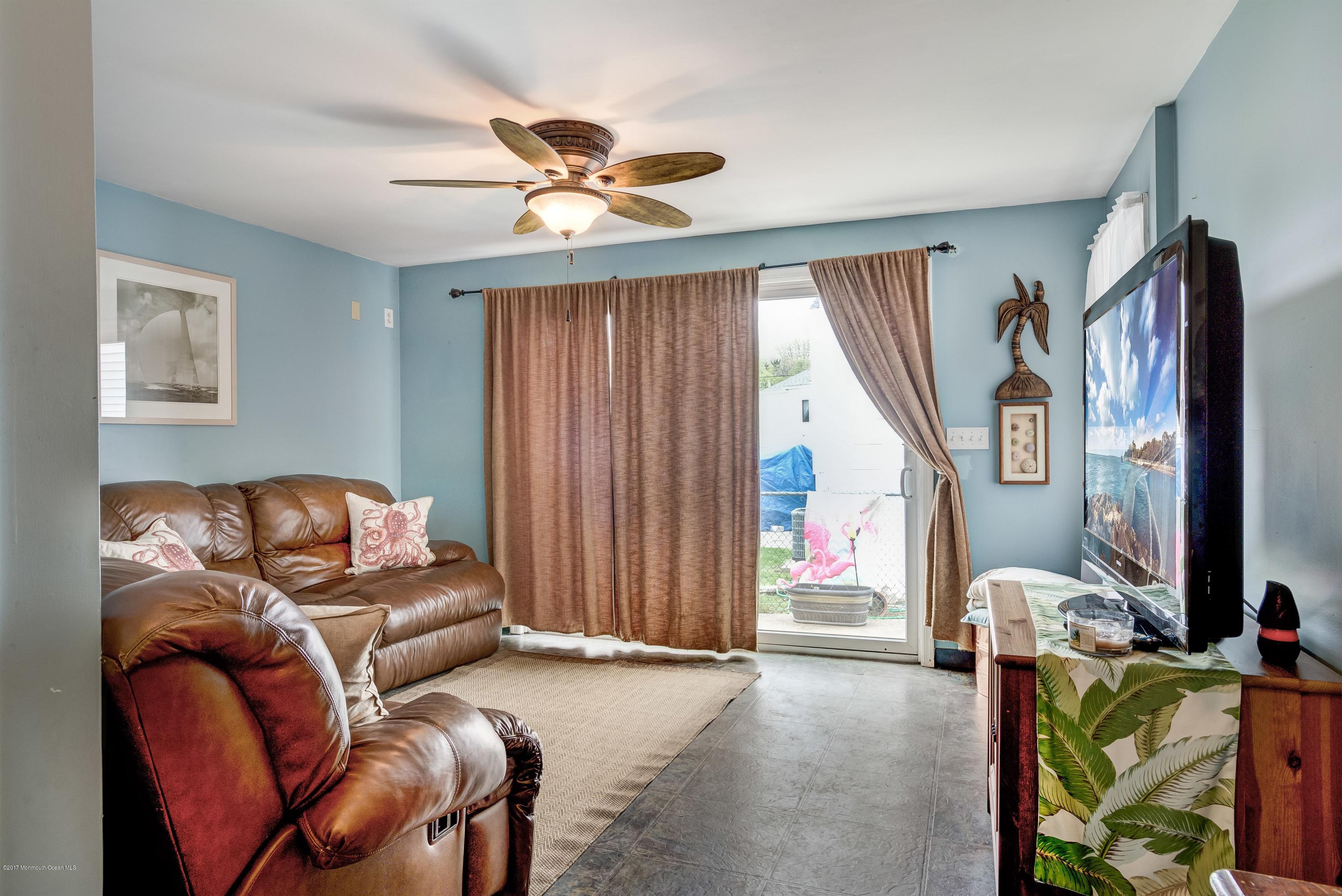401 Stone Road Union Beach, NJ 07735 - Photo 18 of 26 a living room with furniture and a window