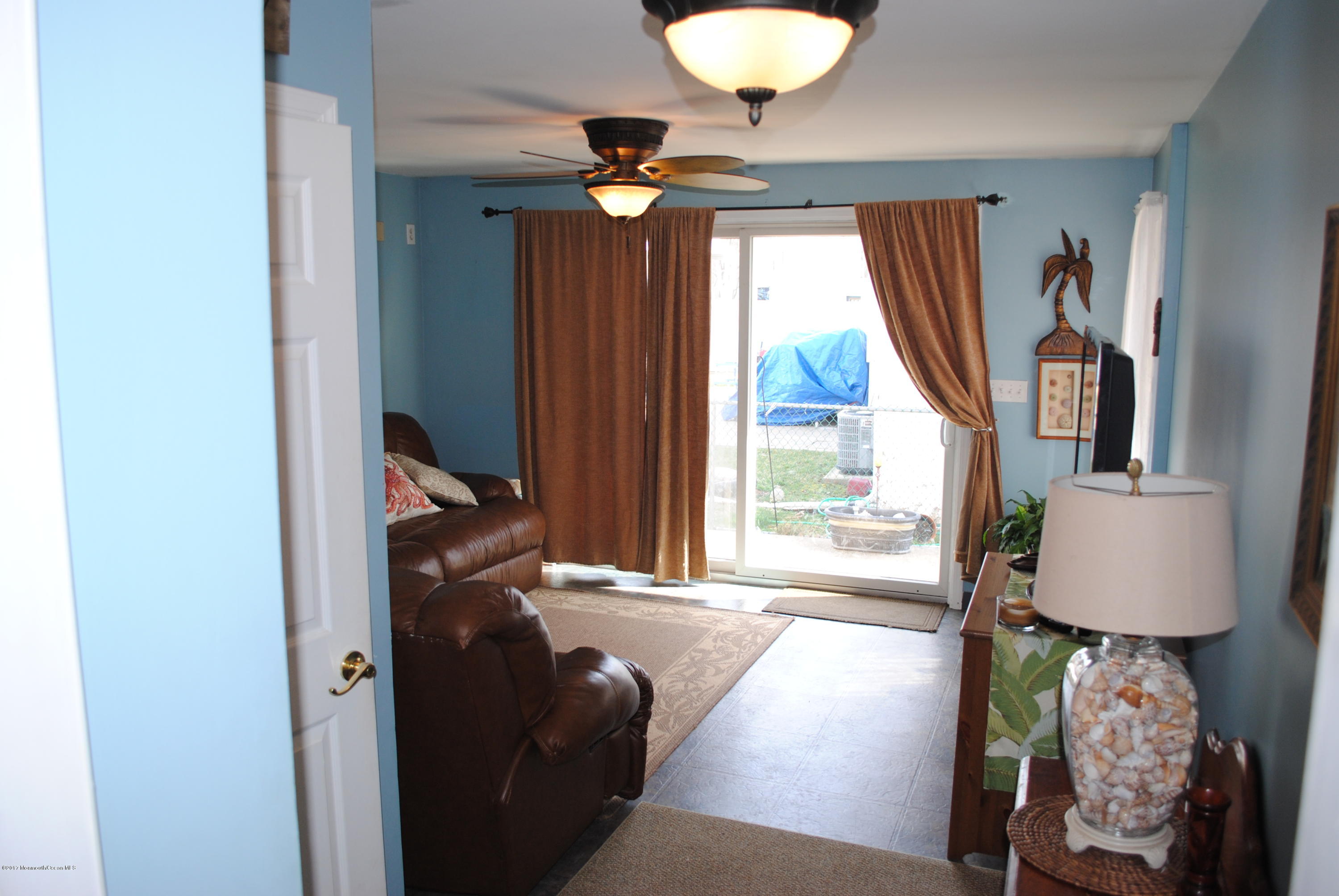 401 Stone Road Union Beach, NJ 07735 - Photo 9 of 26 a living room with furniture and a window