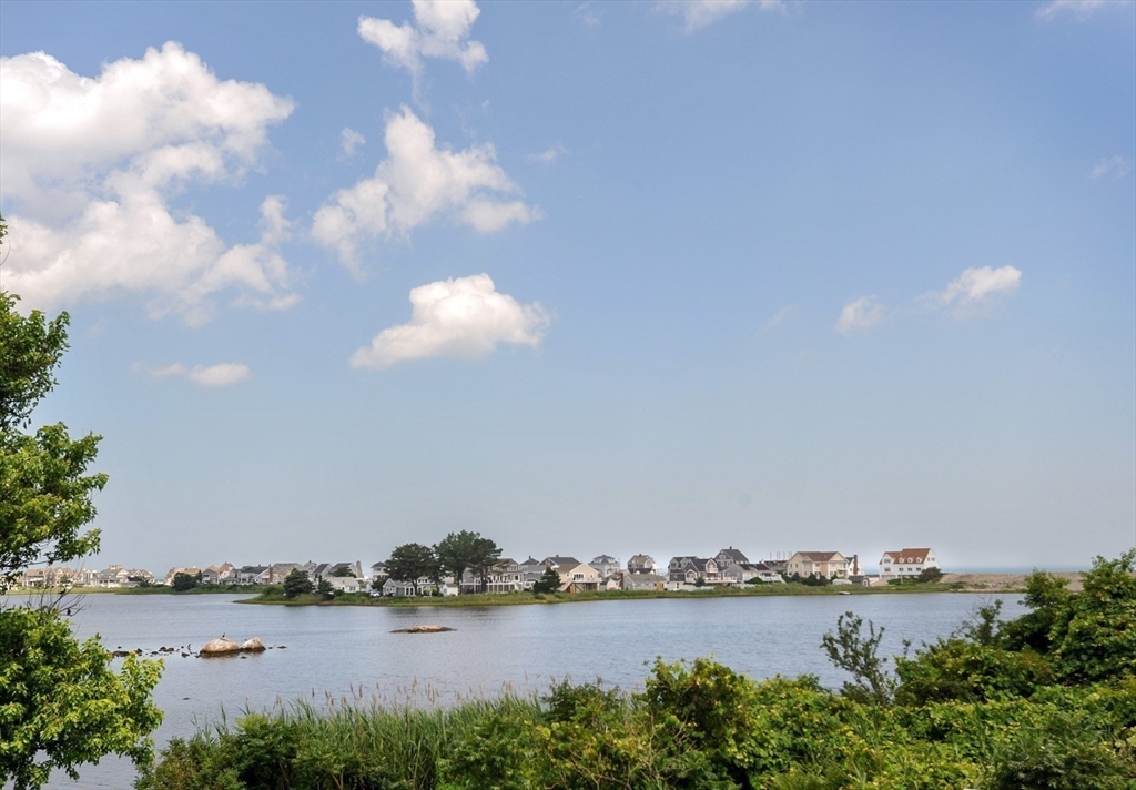 430 Hatherly Road, Unit EXHIBIT “A” Scituate, MA 02066 - Photo 17 of 18 a view of a lake with houses in the back