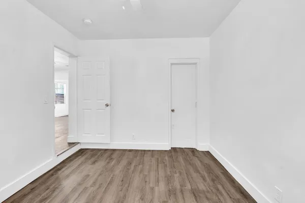 an empty room with wooden floor