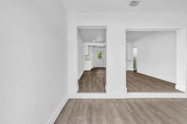 a view of room with wooden floor