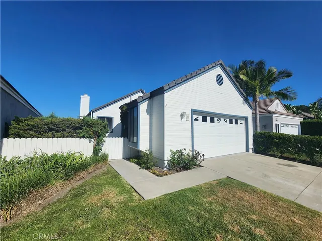 a front view of a house with a yard and outdoor seating