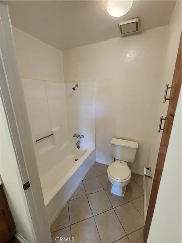 a bathroom with a toilet and a bathtub