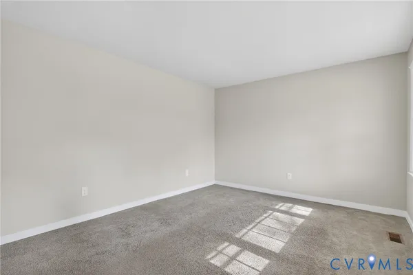 a kitchen with wooden floors and white cabinets