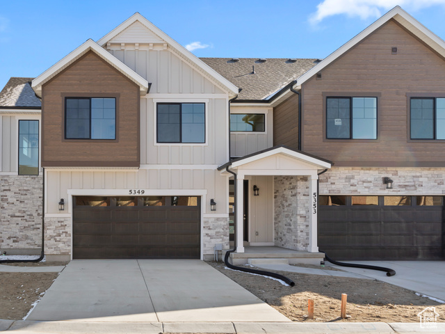657 West Cottage Rdg Lane, Unit 125 Murray, UT 84123 - Photo 1 of 1 Multi unit property with concrete driveway, stone siding, board and batten siding, a residential view, and a garage