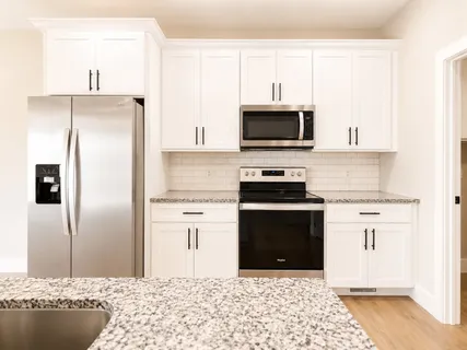 a kitchen with refrigerator and car