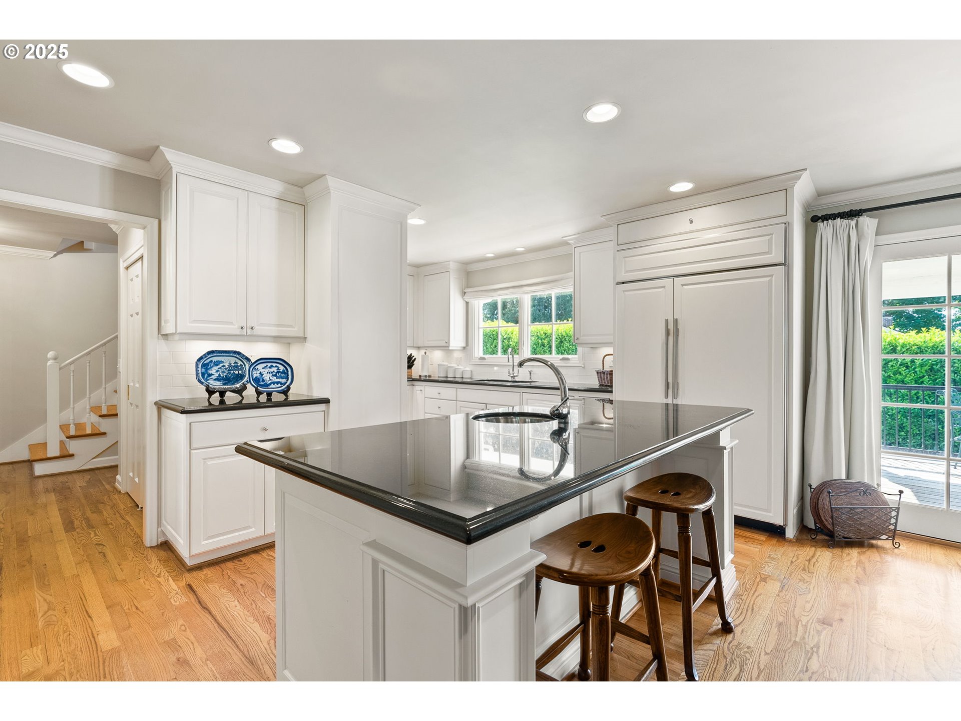 2100 Hillside Drive Lake Oswego, OR 97034 - Photo 14 of 40 a kitchen with granite countertop kitchen island stainless steel appliances a sink and a refrigerator