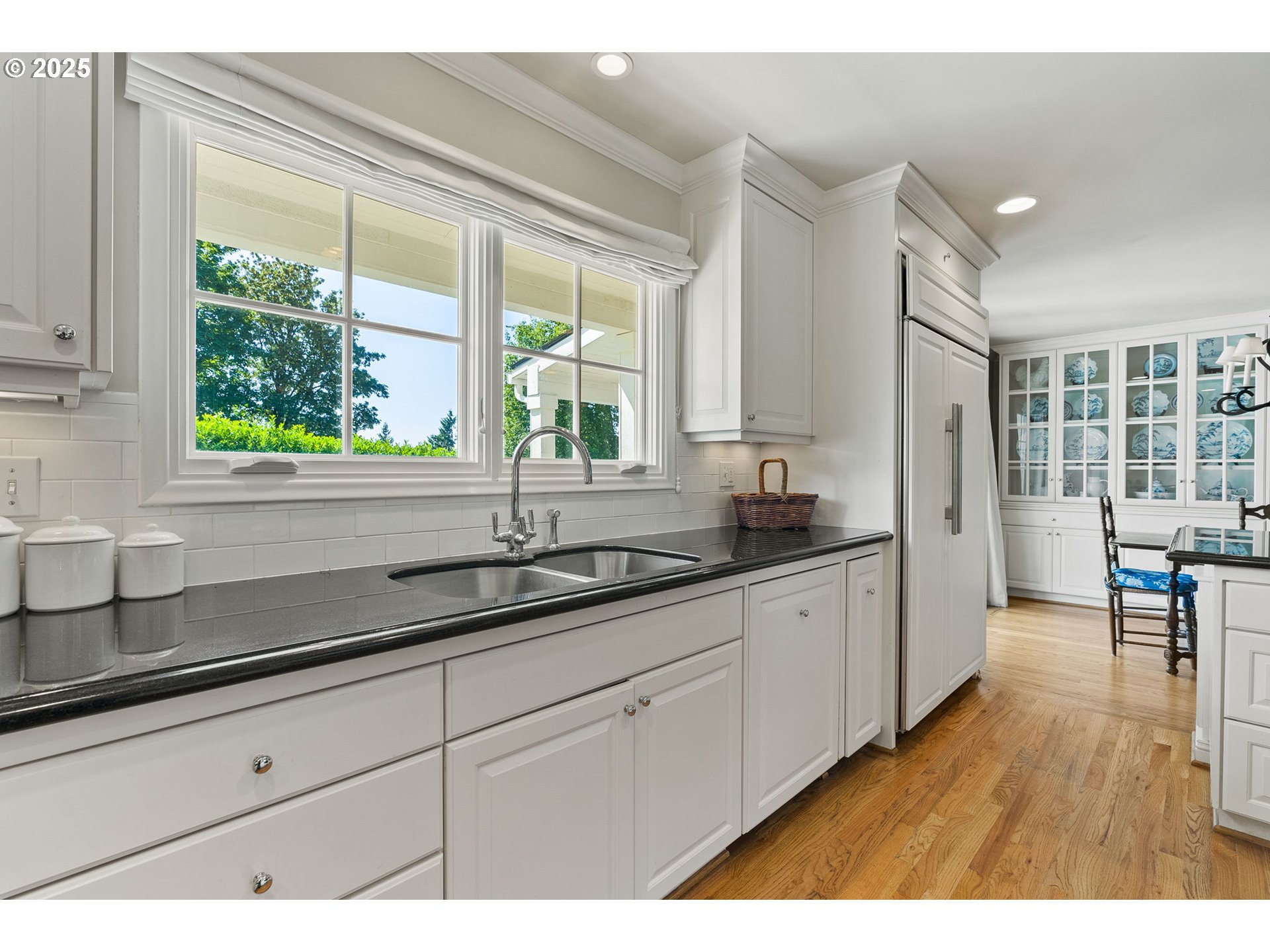 2100 Hillside Drive Lake Oswego, OR 97034 - Photo 16 of 40 a kitchen with granite countertop white cabinets and a large window