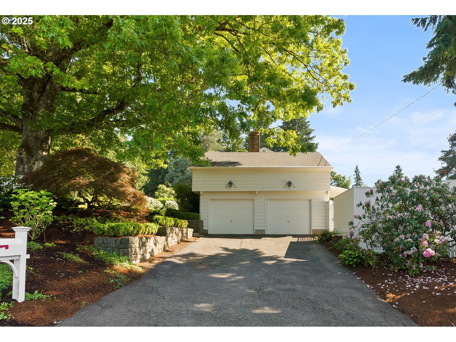 2100 Hillside Drive Lake Oswego, OR 97034 - Photo 34 of 40 a front view of a house with a yard and garage