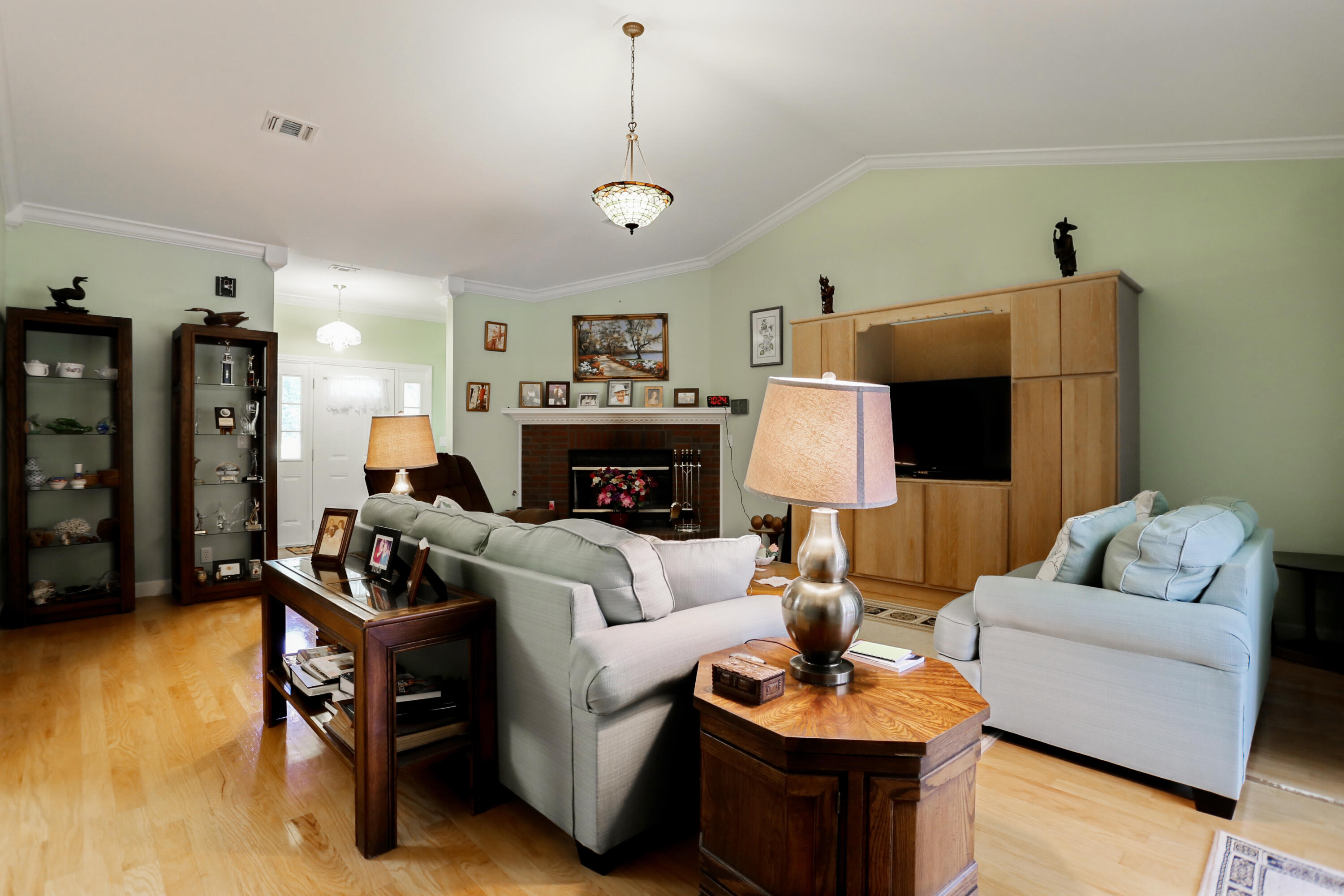 5467 Old River Road Baker, FL 32531 - Photo 23 of 55 a living room with furniture a fireplace and a flat screen tv