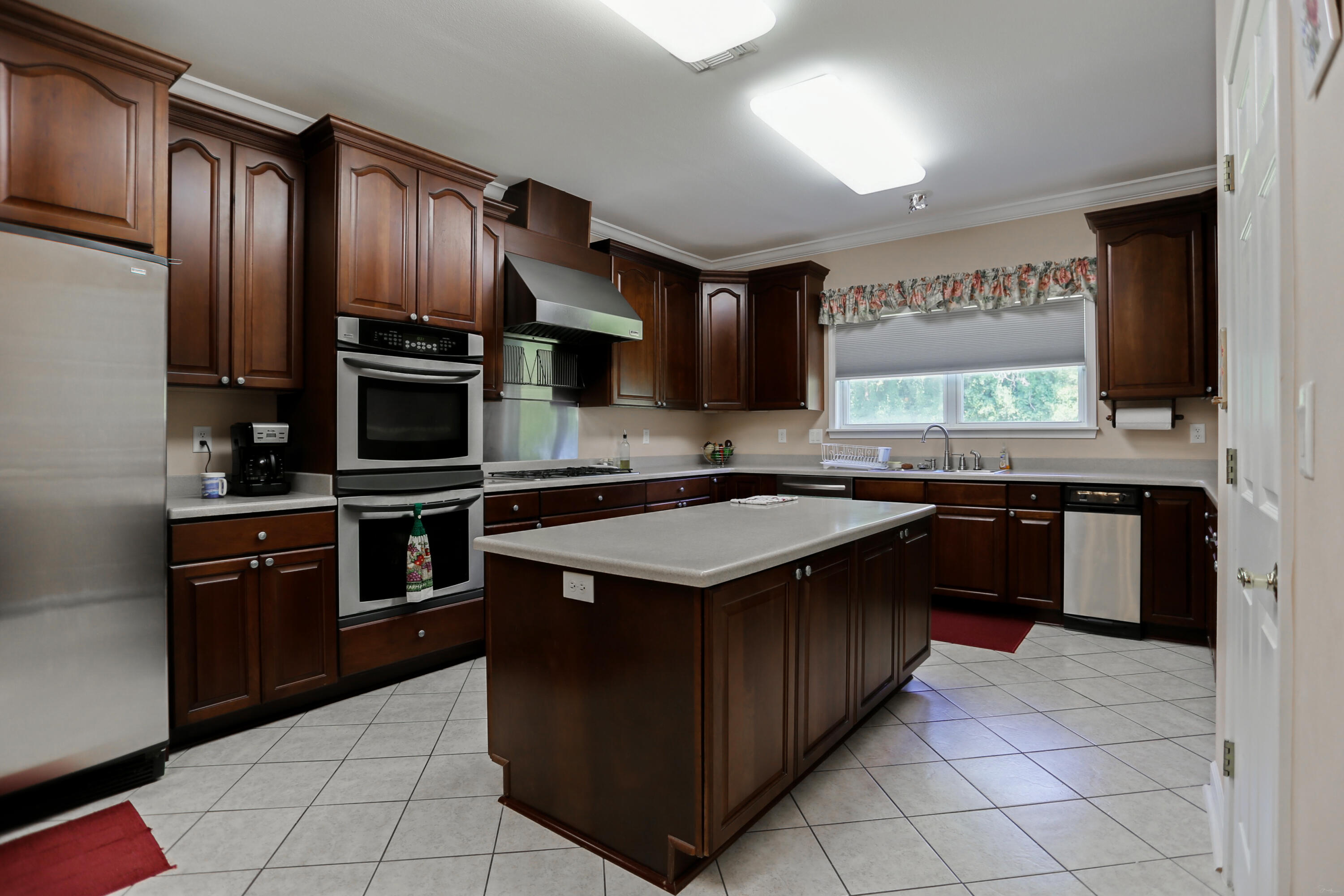5467 Old River Road Baker, FL 32531 - Photo 29 of 55 a kitchen with stainless steel appliances granite countertop a stove a sink and a refrigerator
