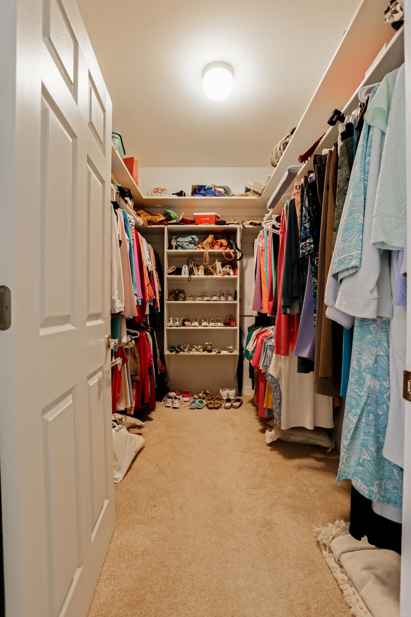 5467 Old River Road Baker, FL 32531 - Photo 36 of 55 a view of walk in closet with clothes and shoes