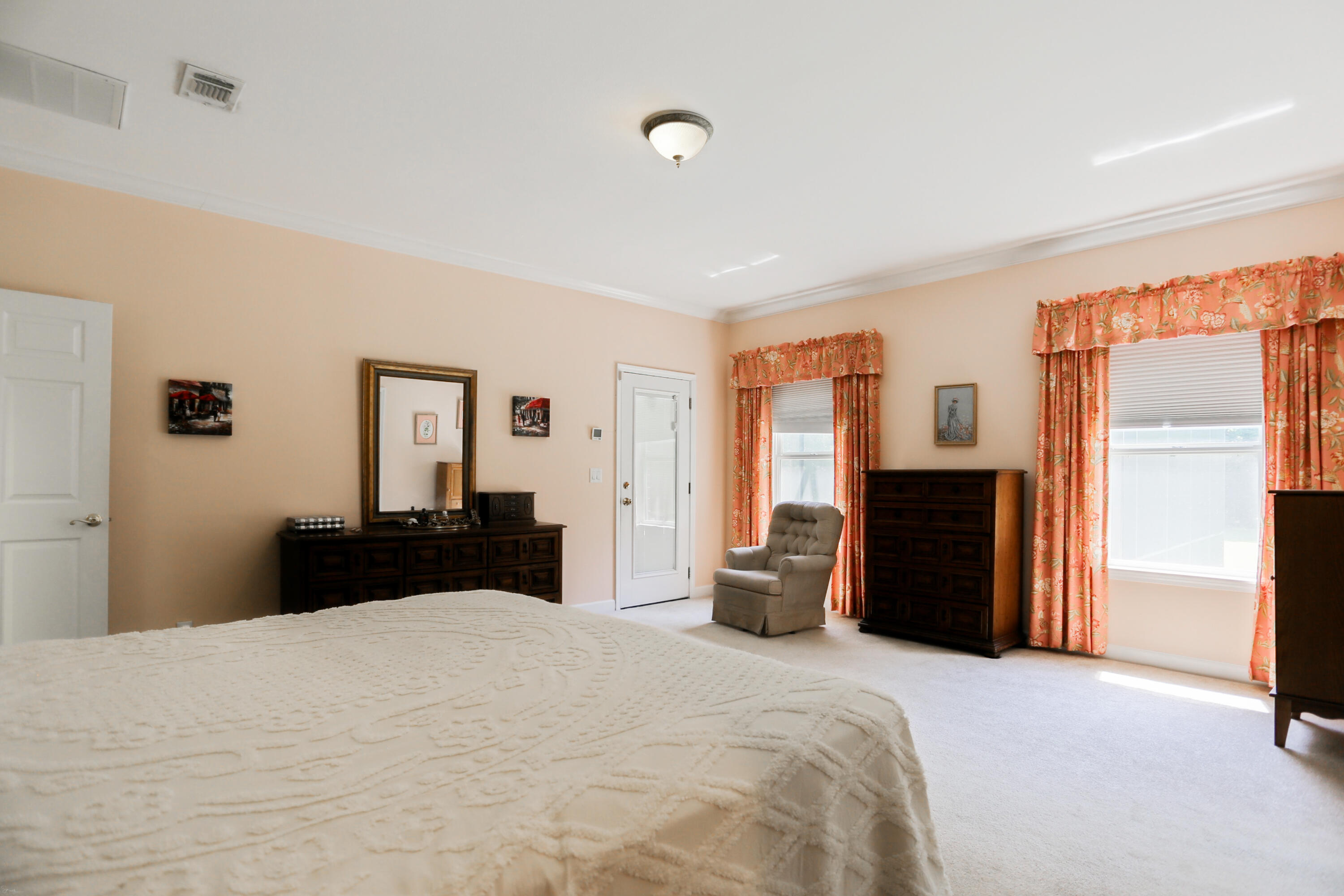 5467 Old River Road Baker, FL 32531 - Photo 39 of 55 a bedroom with a bed and dresser with mirror