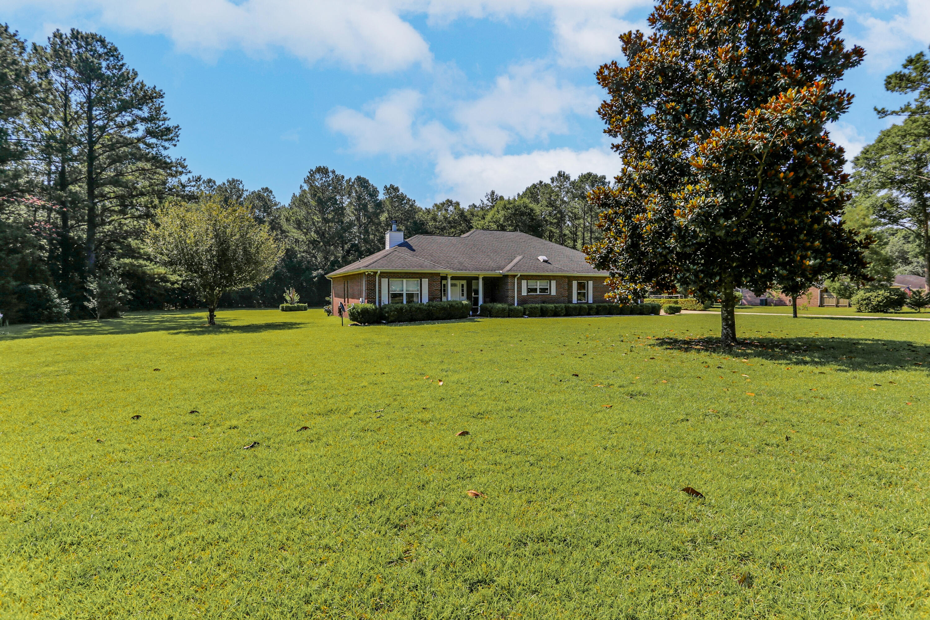 5467 Old River Road Baker, FL 32531 - Photo 4 of 55 a view of swimming pool with lawn chairs and large trees
