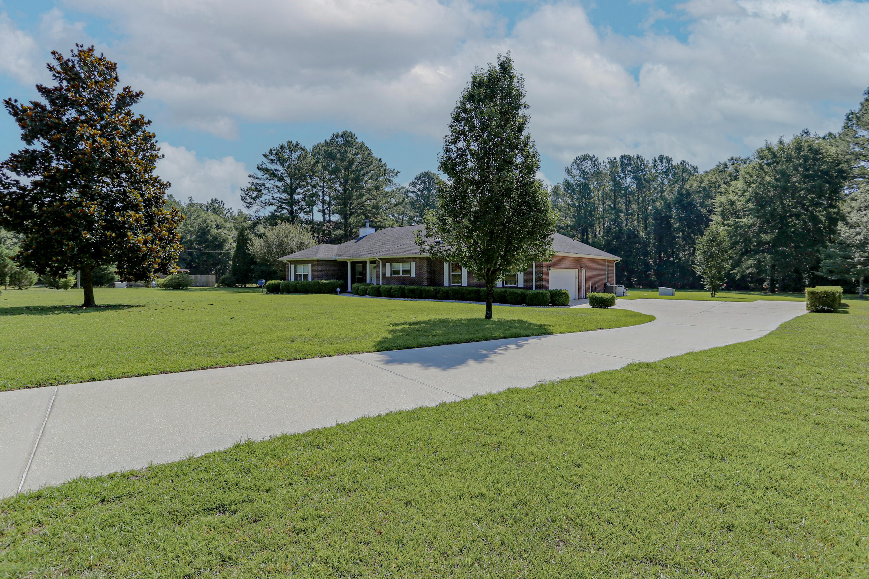 5467 Old River Road Baker, FL 32531 - Photo 6 of 55 a view of a house with a big yard and palm trees