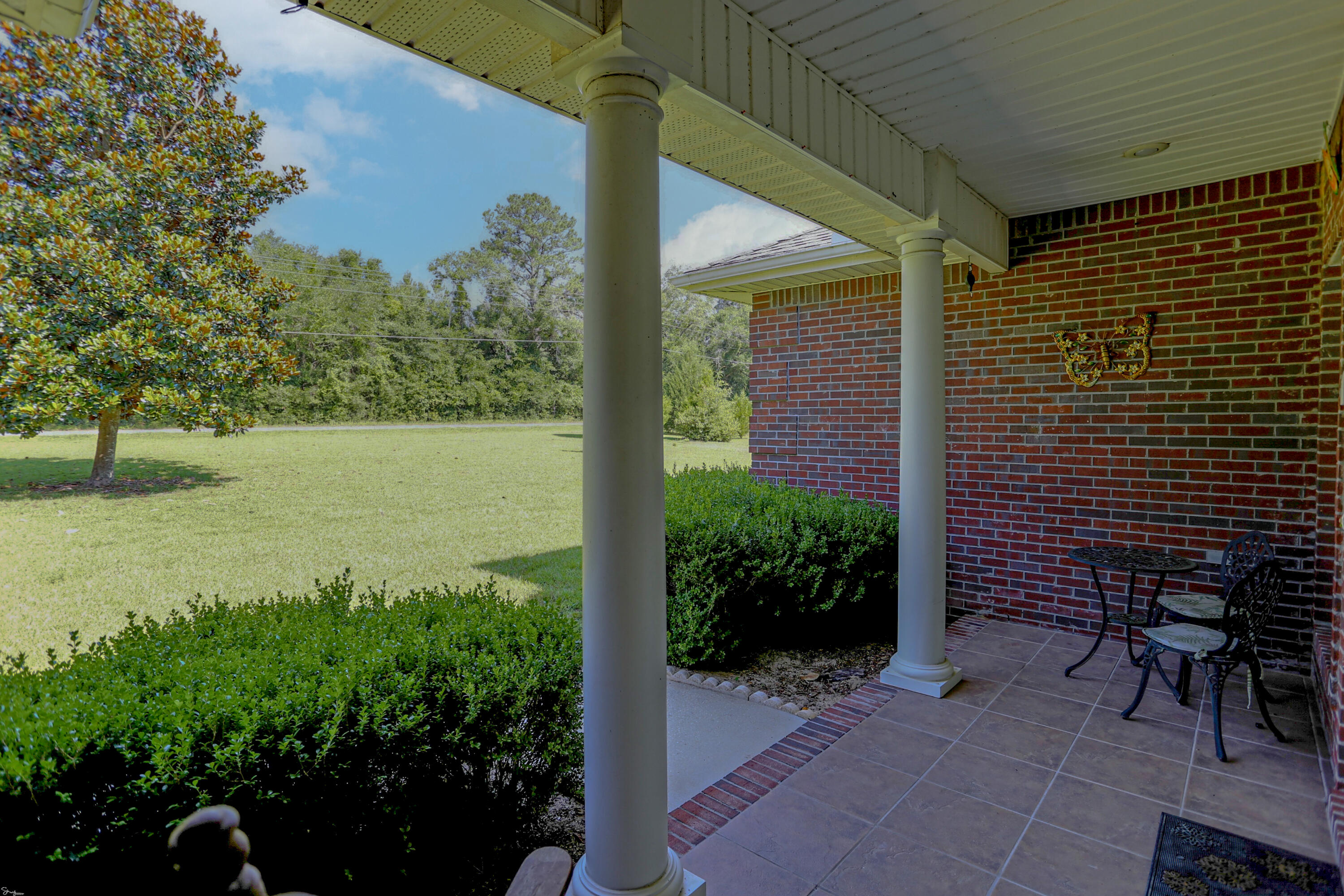 5467 Old River Road Baker, FL 32531 - Photo 10 of 55 a view of a backyard with plants and a patio