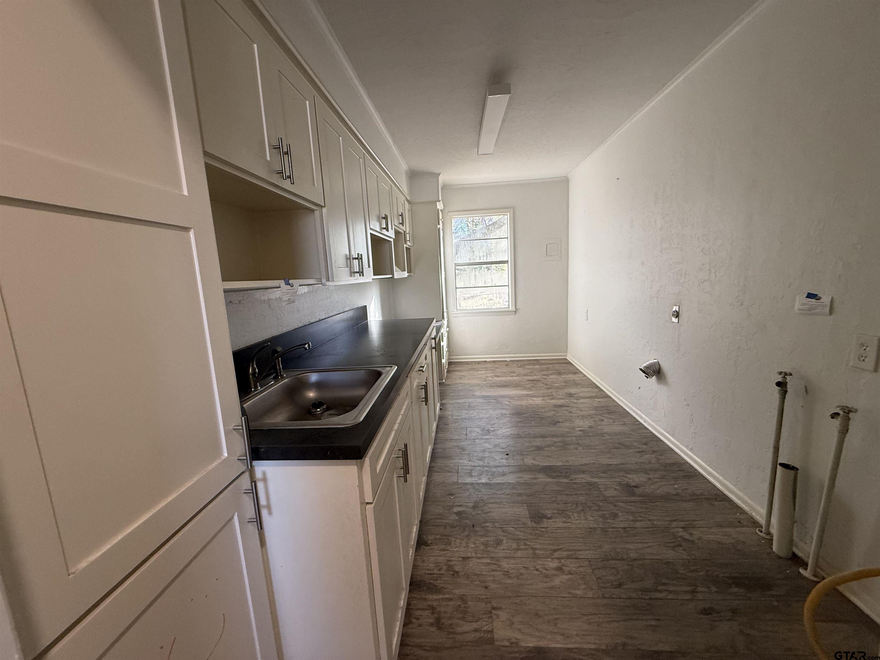207 South Sun Camp Road White Oak, TX 75693 - Photo 12 of 18 a kitchen with a refrigerator and a sink