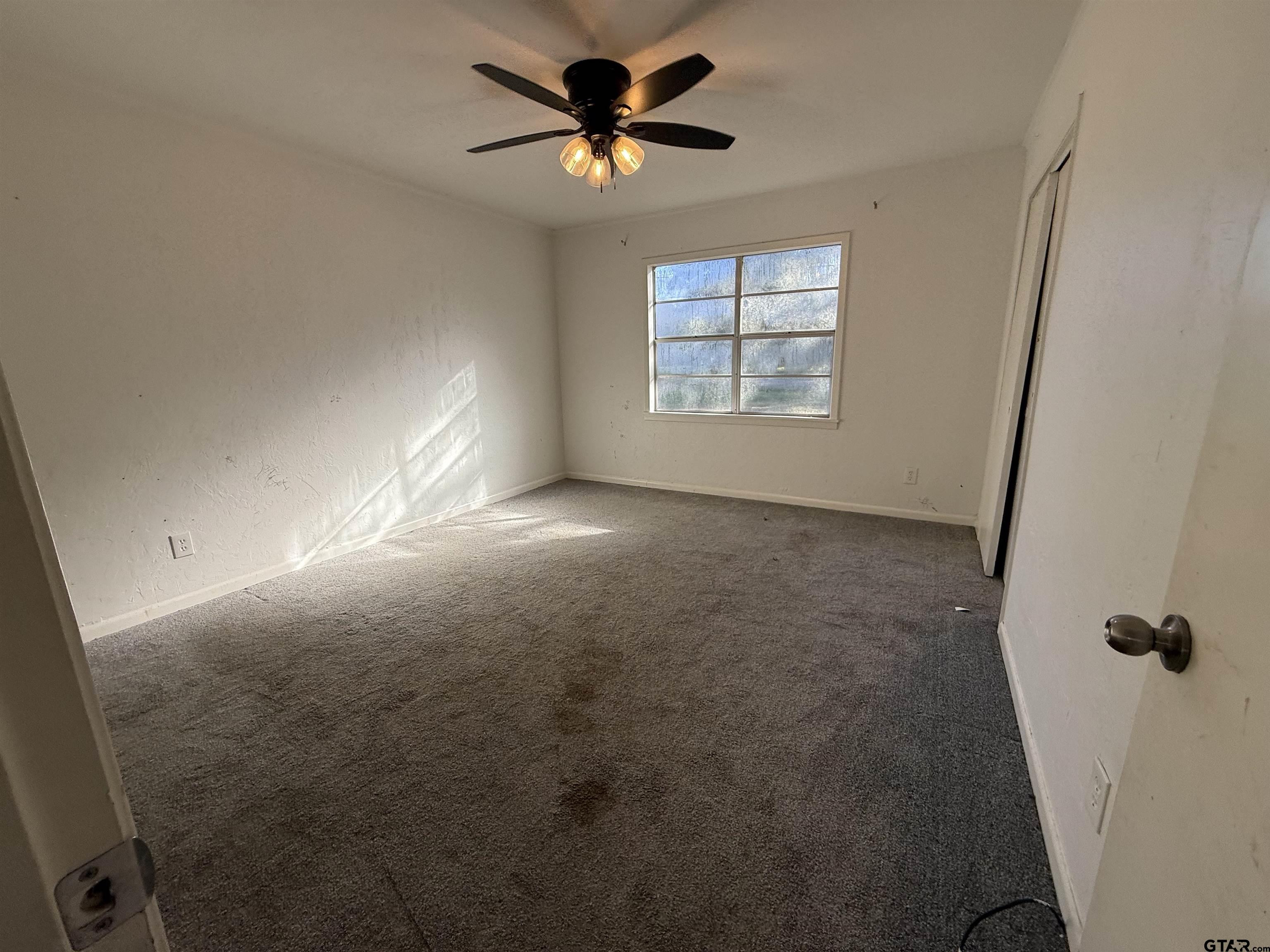 207 South Sun Camp Road White Oak, TX 75693 - Photo 9 of 18 wooden floor in an empty room with a window