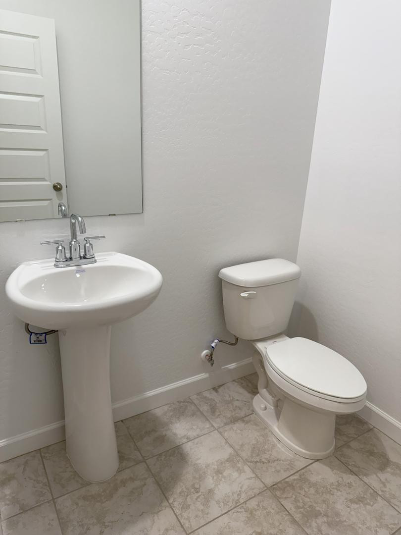 1840 West Spaulding Avenue Apache Junction, AZ 85120 - Photo 22 of 53 a bathroom with a sink toilet and mirror