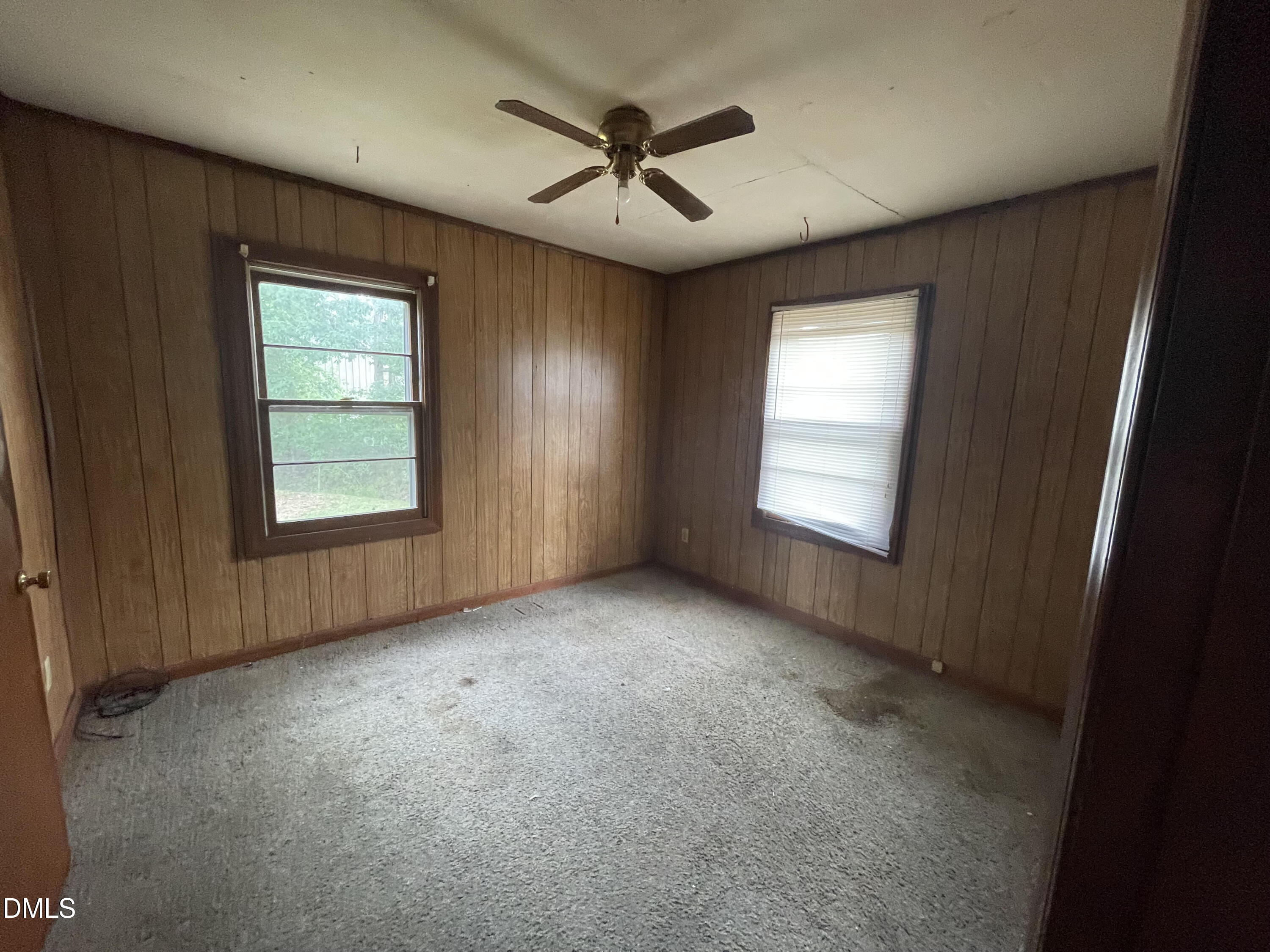 1023 Leasburg Road Roxboro, NC 27573 - Photo 8 of 12 an empty room with windows and ceiling fan