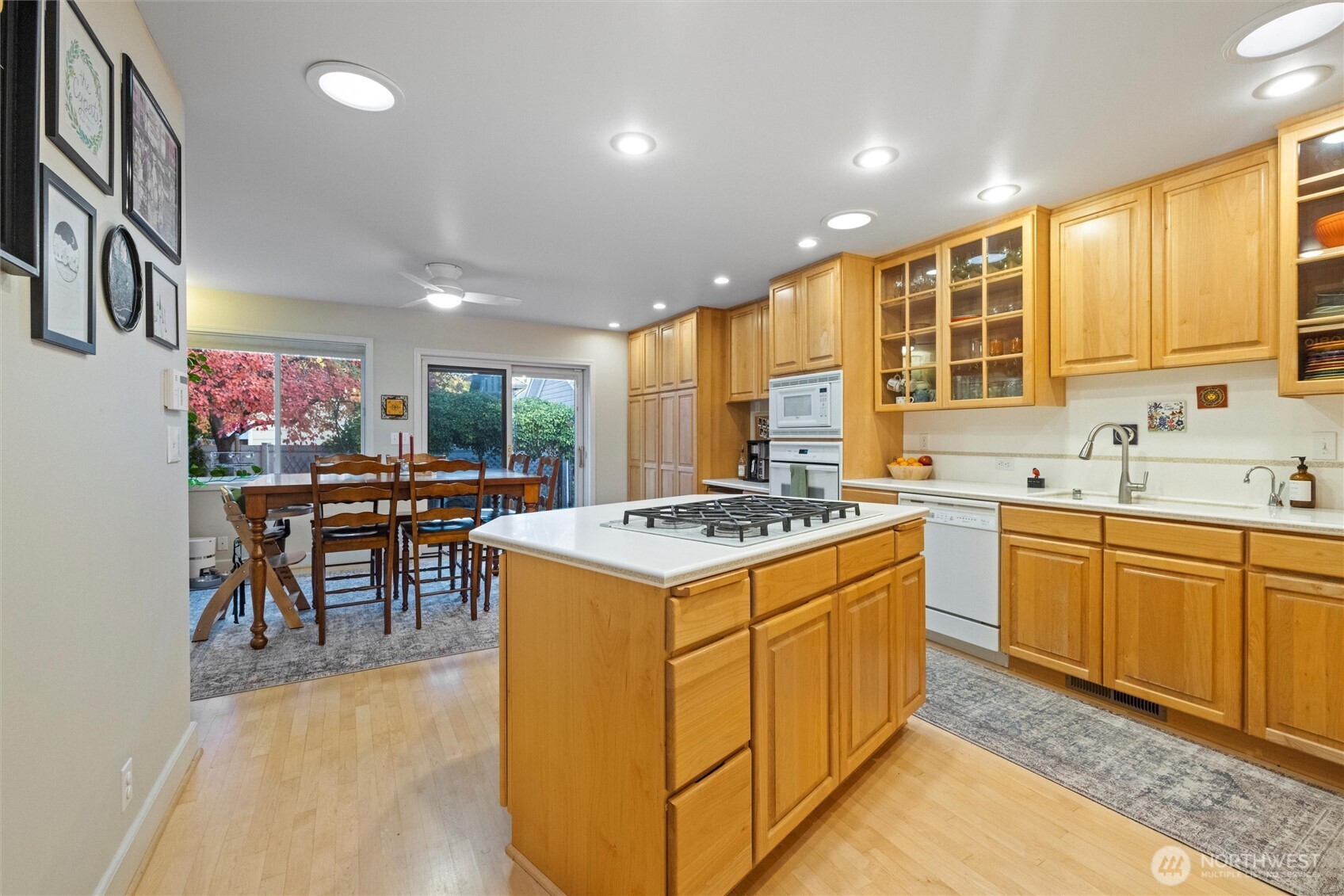 705 Pearson Street Walla Walla, WA 99362 - Photo 11 of 39 a kitchen with a stove a sink a kitchen island with chairs and refrigerator
