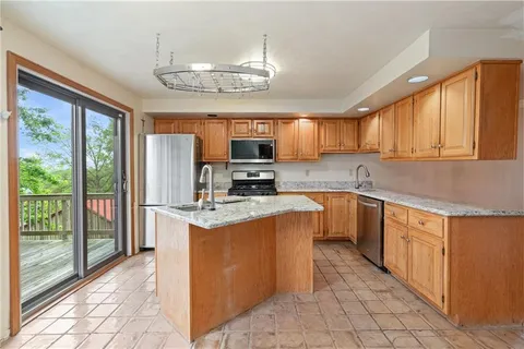 a dining room with furniture a window and a chandelier